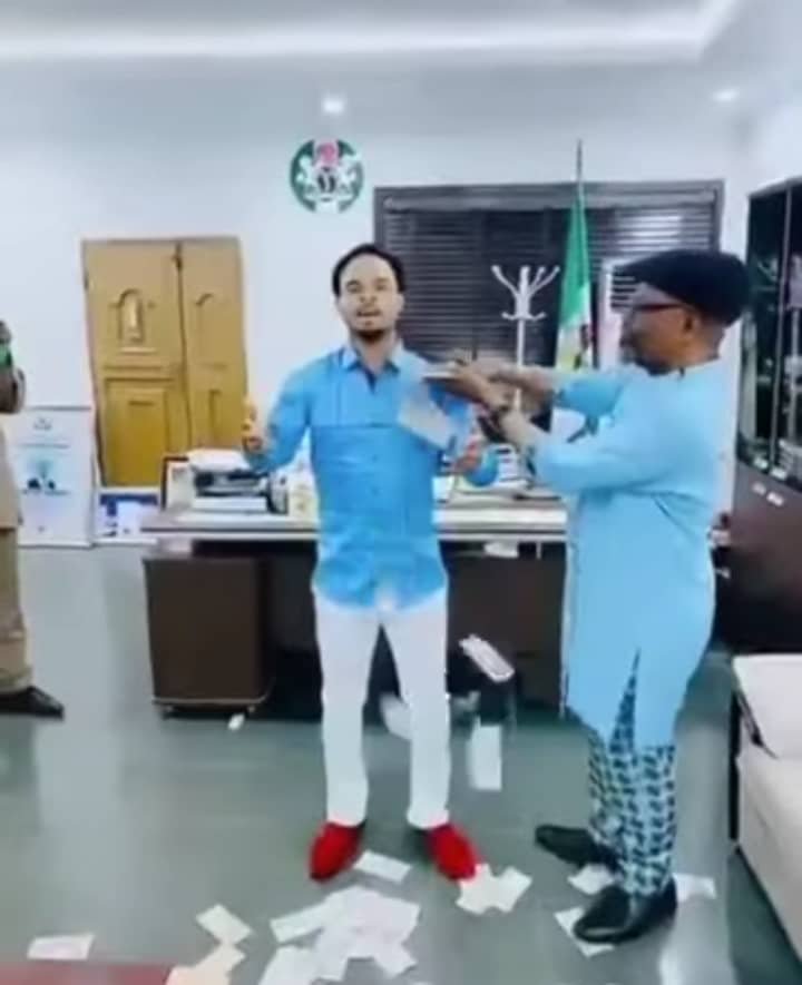Spraying money on Odumeje in the office